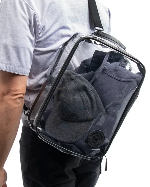 Clear Utility Bag containing pants, a shirt and a hat