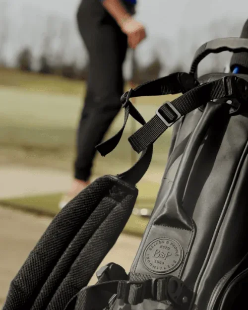 Golf bag with golfer in background