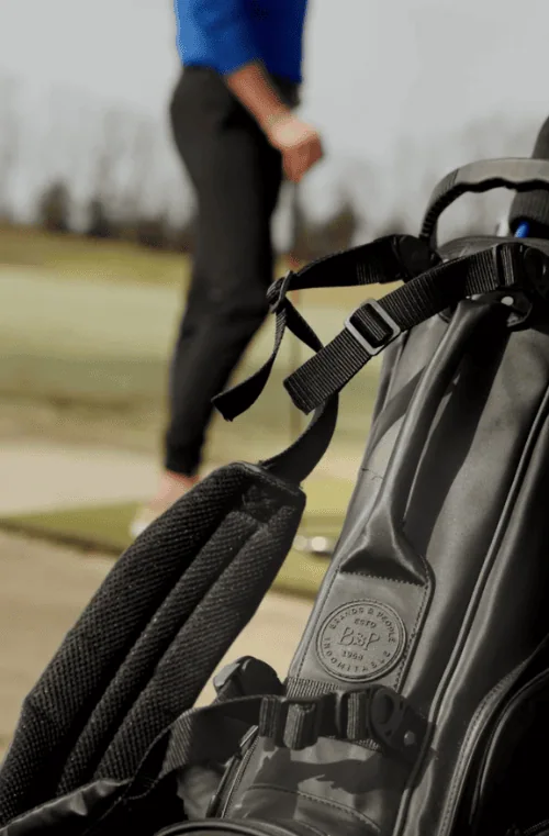 Golf bag with golfer in background